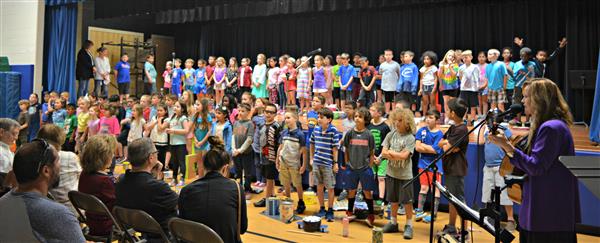 Second-graders perform their songs with KJ 